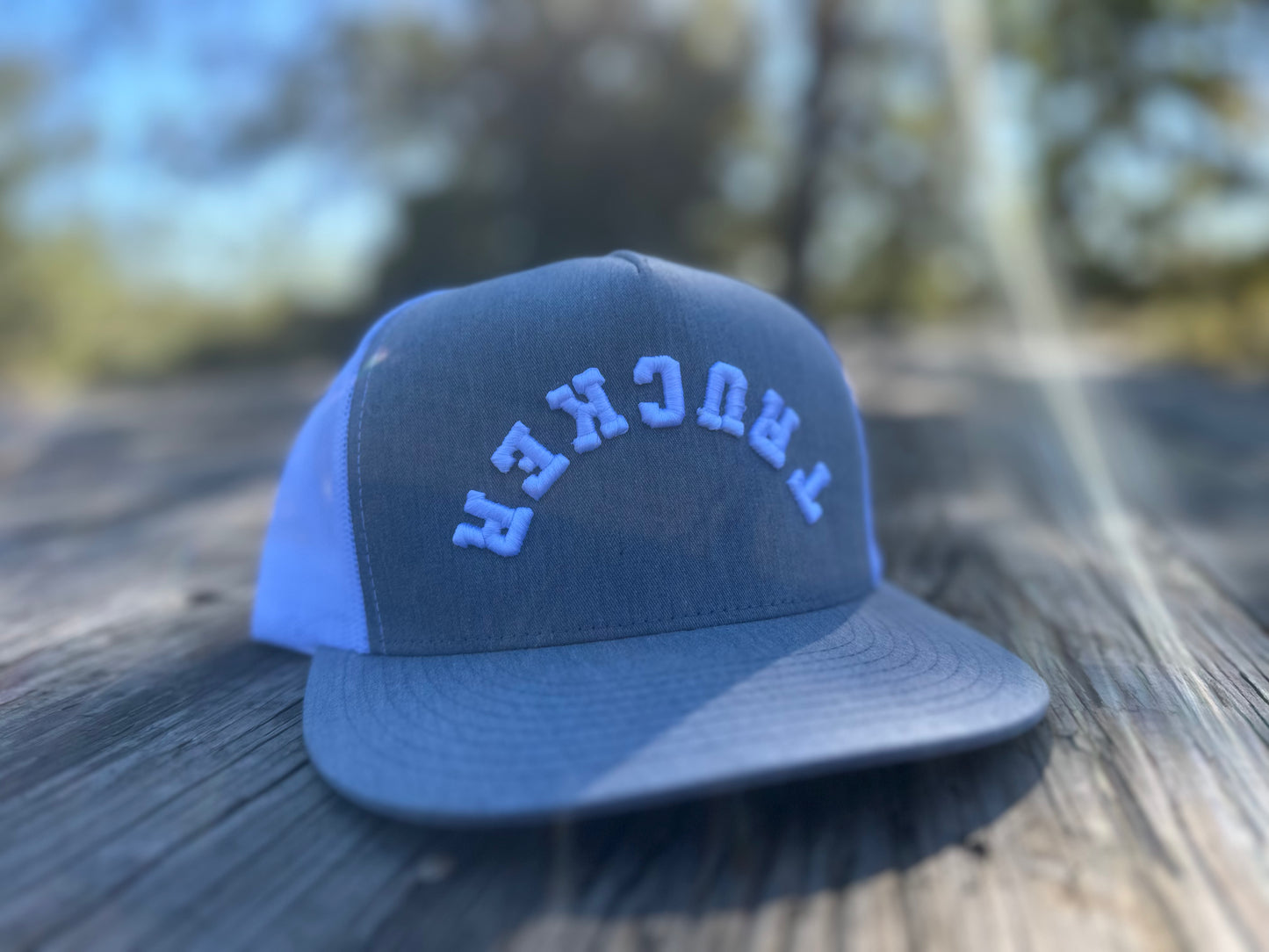 TRUCKER white logo